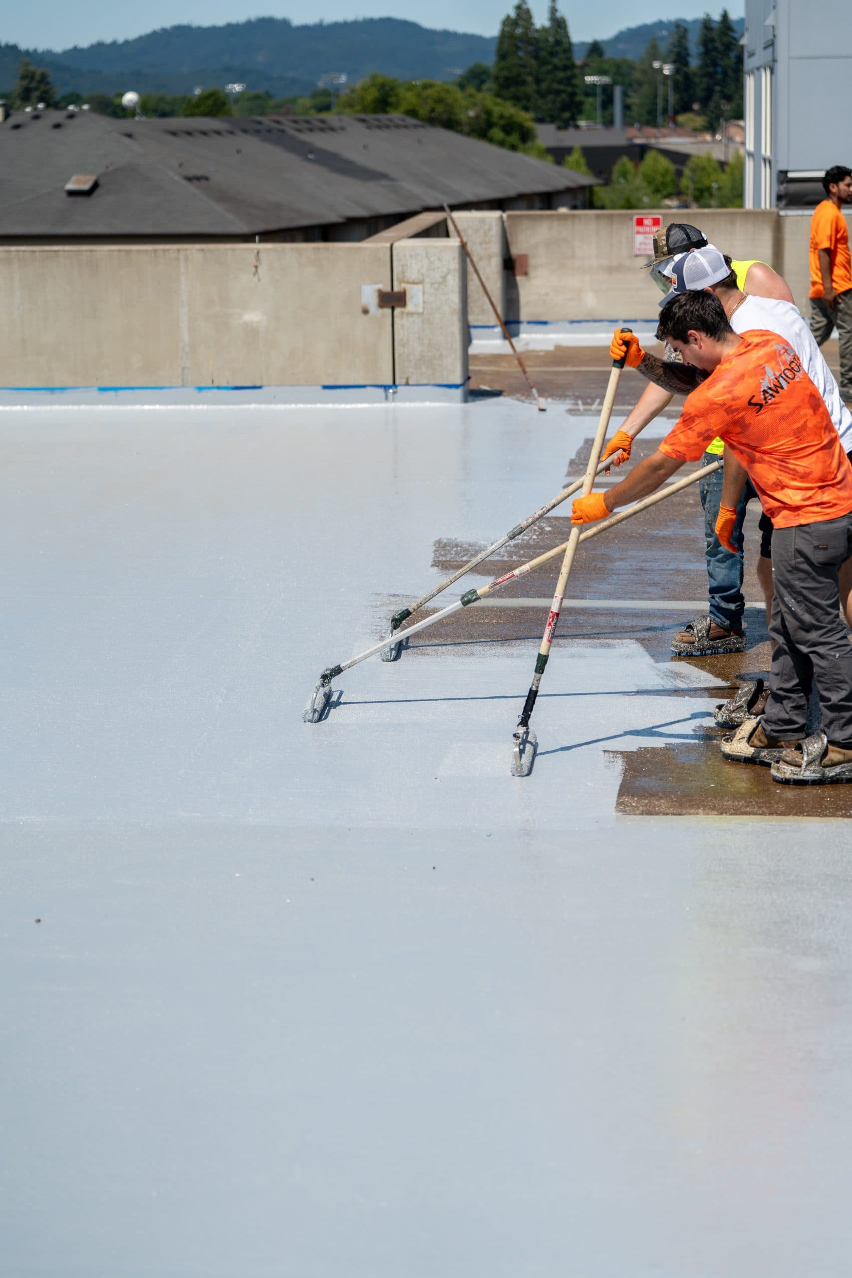 Sawtooth Fortified crew applying a traffic coating system to an elevated deck